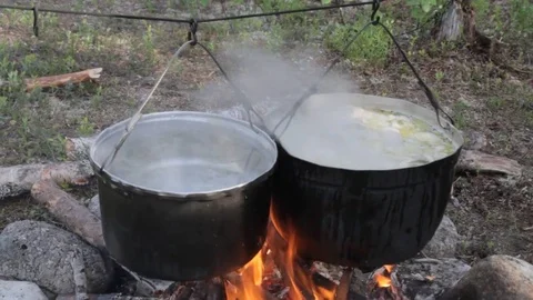 Old kettle on a marching fire Stock Footage 79525346