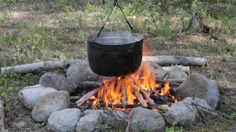 Old kettle on a marching fire Stock Footage 79525402