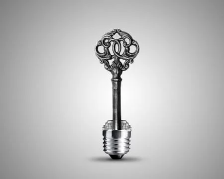 Old key in light bulb Stock Photos