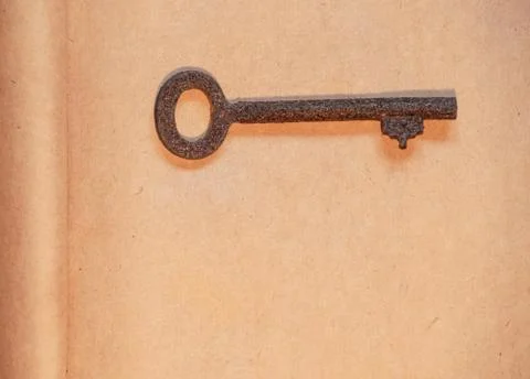 Old key on paper background Stock Photos
