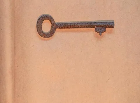 Old key on paper background Stock Photos