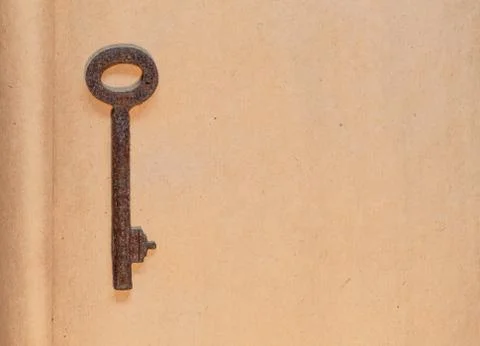 Old key on paper background Foto stock