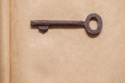 Old key on paper background Stock Photos