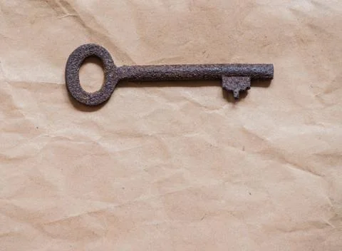 Old key on paper background Stock Photos