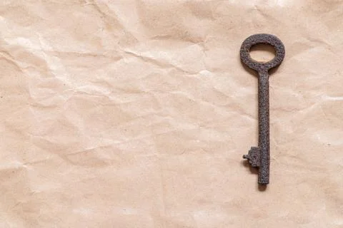 Old key on paper background Foto stock