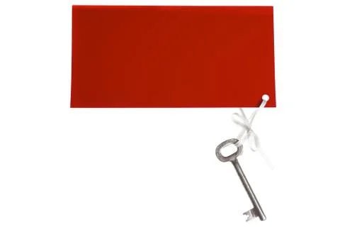 Old key with red label Stock Photos