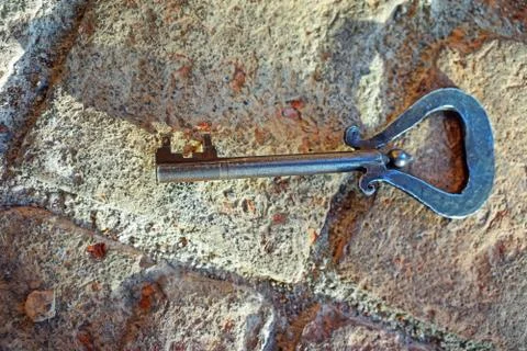 Old key on stone background Foto stock