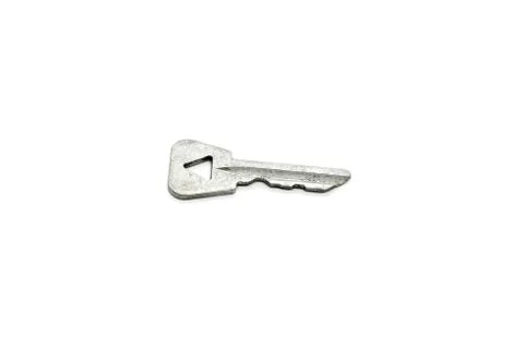Old key with a triangular hole on white background 스톡 사진