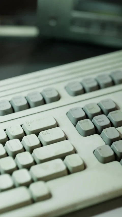 Old keyboard on a desk with worn keys and clear signs of use Stock Footage 335964132