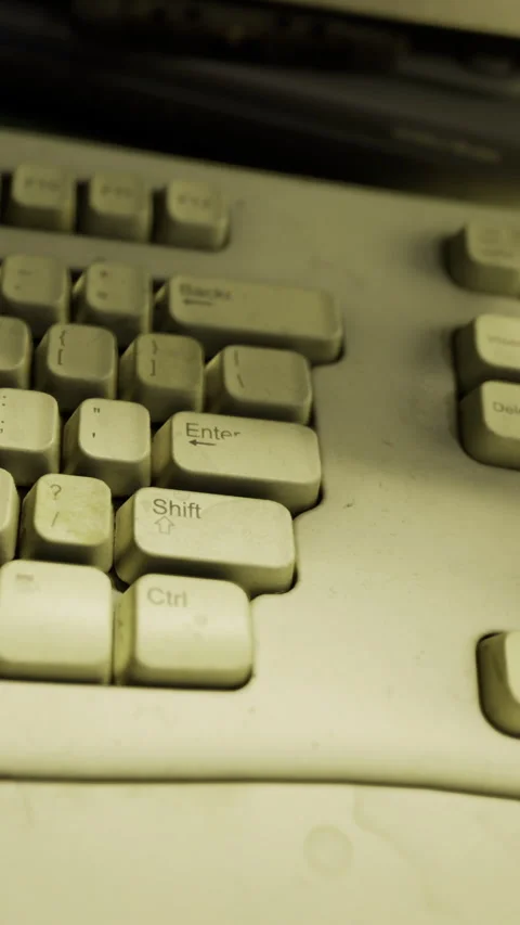 Old keyboard showing dust and signs of wear in a workspace setting Stock Footage 335093228