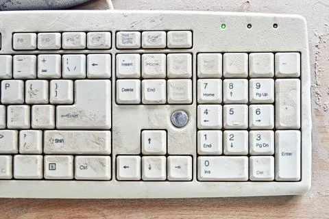 Old keyboard on table and covered in thick dust close-up Stock Photos
