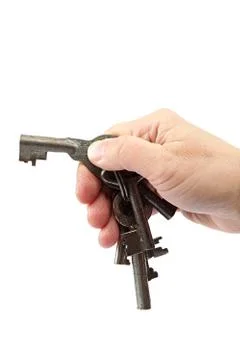Old keys in hand on a white background. Stock Photos