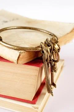 Old keys on old book Stock Photos