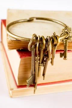 Old keys on old book Stock Photos