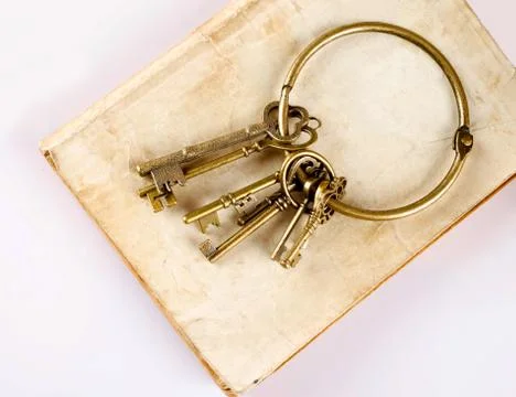Old keys on old book Stock Photos
