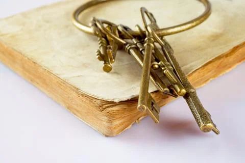 Old keys on old book Stock Photos