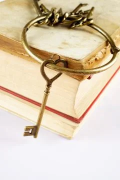 Old keys on old book Stock Photos