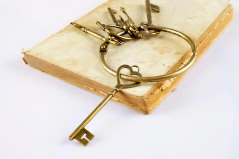 Old keys on old book Stock Photos