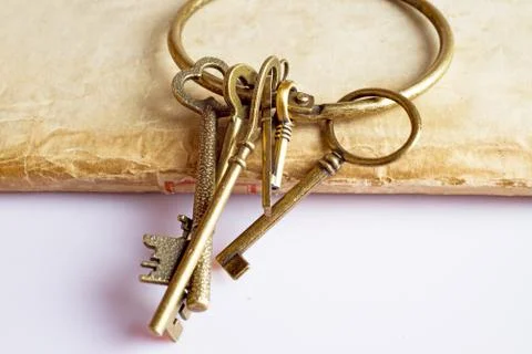 Old keys on old book Stock Photos