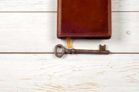 Old keys on a old book on rustic wooden background. Stock Photos