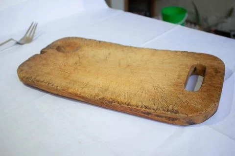 Old kitchen board, used for chopping cheese or vegetables Stock Photos