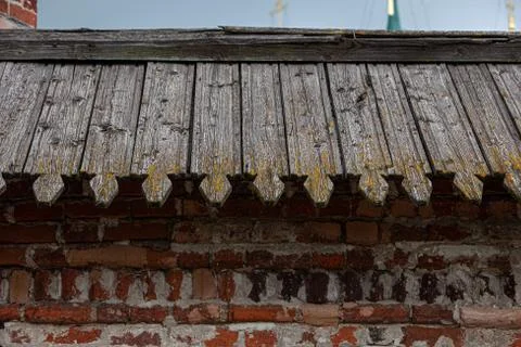 Old kremlin wall of brick cluttering with timber roofing close up Stock Photos