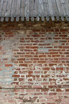 Old kremlin wall of brick cluttering with timber roofing Stock Photos