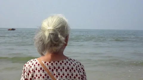 Old lady by the beach Stock Footage 154327930
