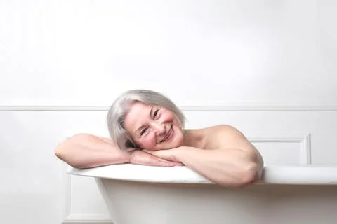 Old lady having a bath Stock Photos