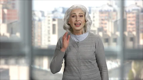 Old lady having hearing problems, holding hand at her ear. Video stock 127281906