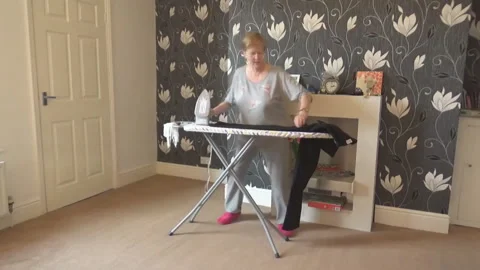 An old lady ironing clothes Stock Footage 85601555