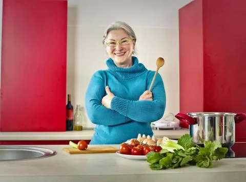 Old lady in the kitchen Stock Photos