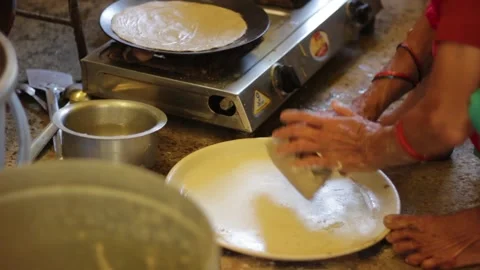 Old lady kneading dough to make Bhakri, an Indian bread like chapatti Stock Footage 146303699