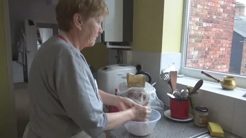 An old lady makes dough Stock Footage 86478132