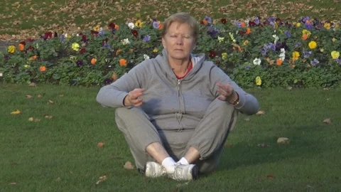 An old lady meditates Stock Footage 86479338