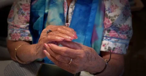 Old lady moves her ring around her finger Stock Footage 81357994