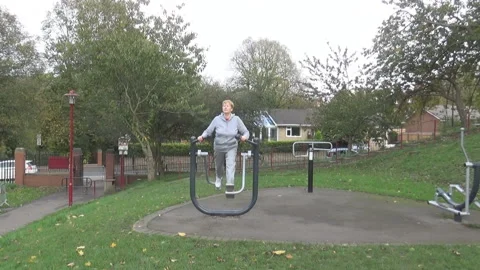 An old lady on outside training apparatus Video stock 86685392