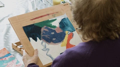 Old lady painting Stock Footage