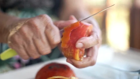 Old lady peeling tomatoes Stock Footage 124260076