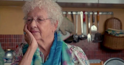 Old lady pensive in the kitchen Stock Footage 81357482