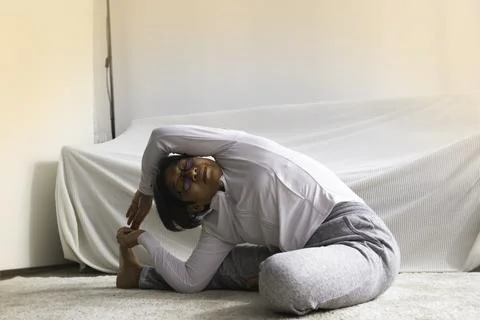 Old lady posing yoga for exercise at living room.for good health Stock Photos