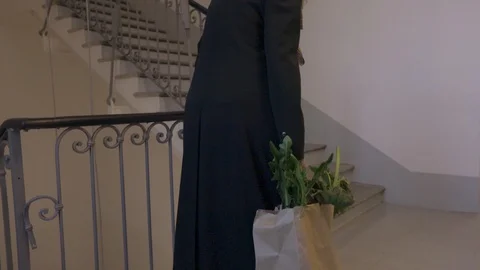 Old lady returns home after food shopping Stock Footage 120790411