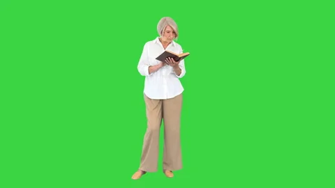 Old lady standing and reading a book on ... | Stock Video | Pond5