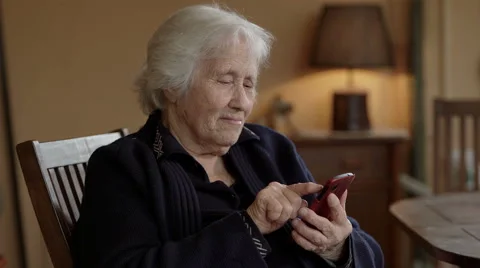 Old lady texts a message on the mobile Stock Footage 63092292