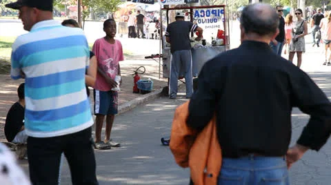Old lady tips singing boy at Porto Alegre's Flea Market (FleaMkt 47) Stock-Footage 23750170