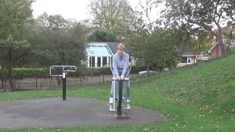 An old lady on a training apparatus Stock Footage 86479090