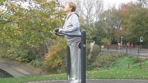 Old lady on a training apparatus Stock Footage 89098616