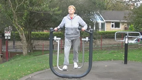 An old lady on a training machine Video stock 86479147