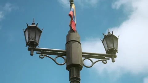 Old lamp post with colombian flag on the top Stock Footage 231942264