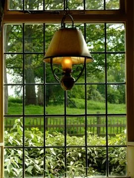 Old lamp by window Stock Photos